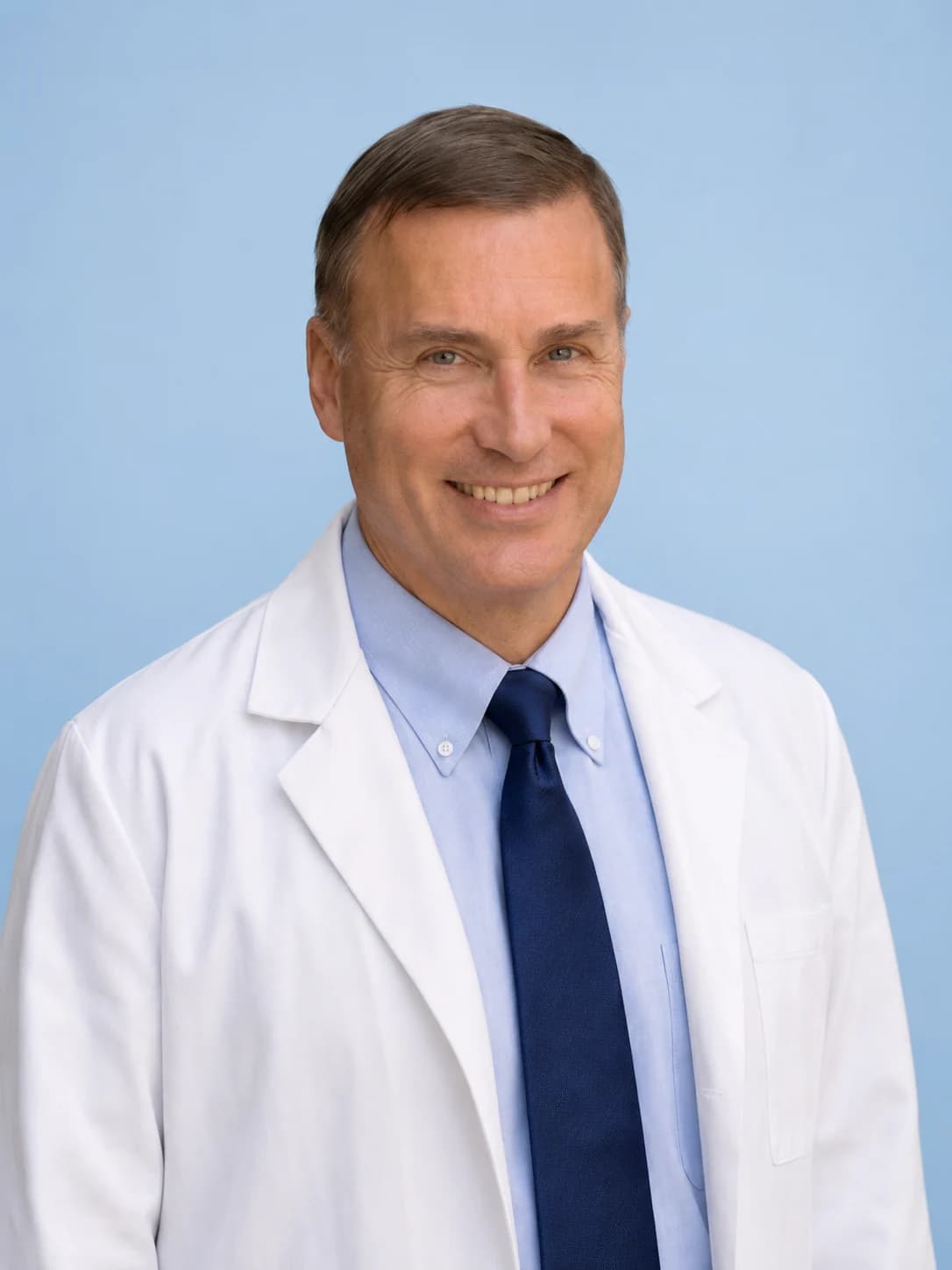 Dr. Jerry Hric, regenerative medicine physician, in his white coat