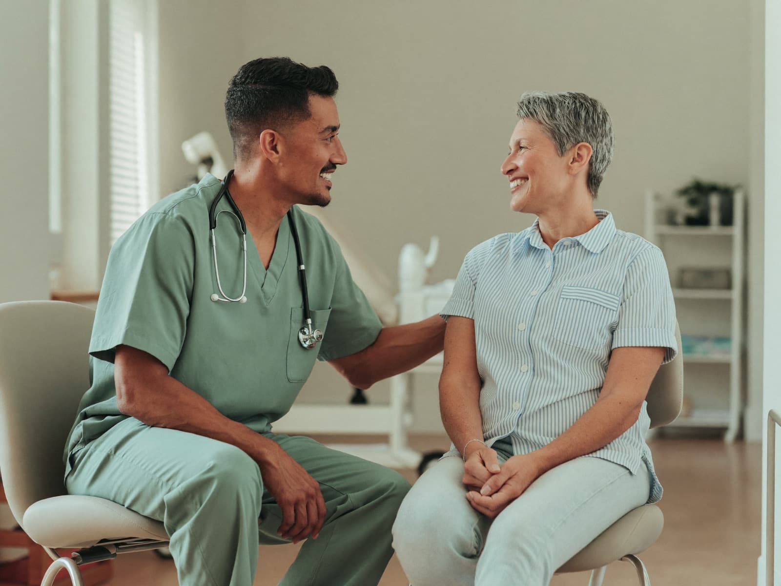 Physician listening to a patient describe her symptoms